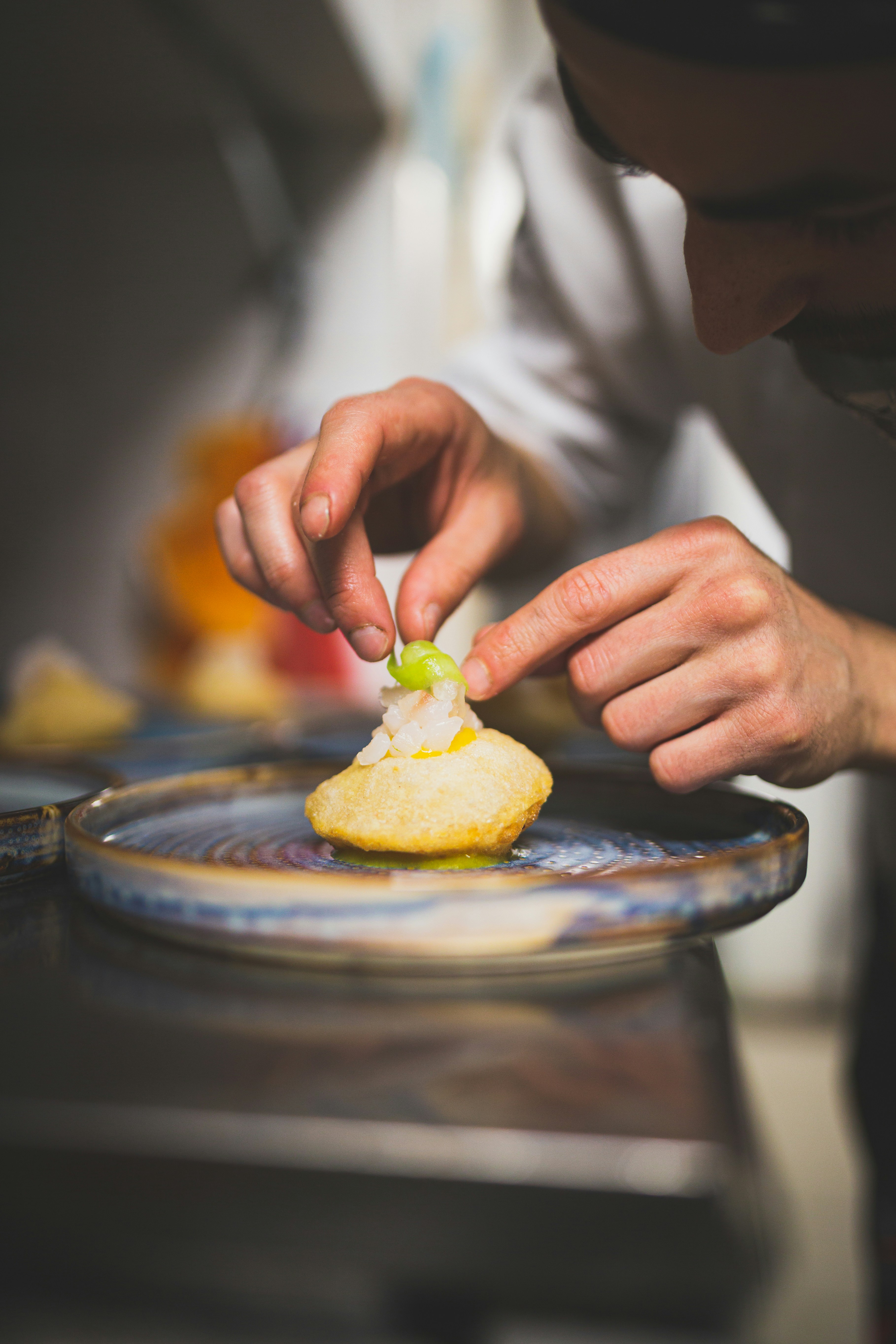 A chef carefully plating a dish for a private tasting menu.